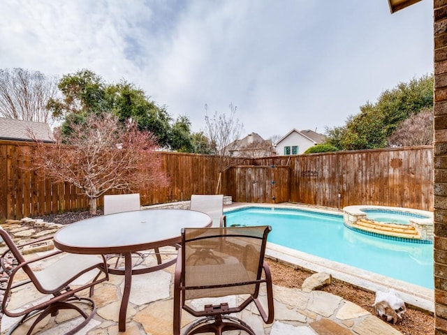 view of swimming pool with a patio and an in ground hot tub