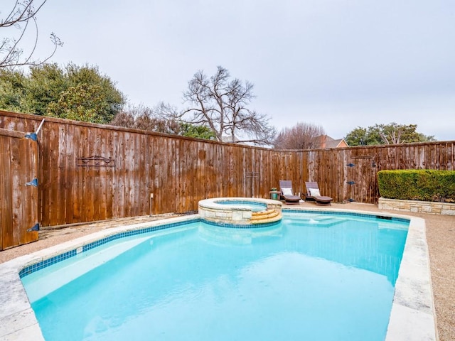 view of swimming pool with an in ground hot tub