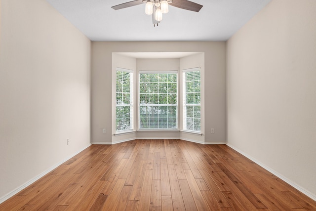 unfurnished room with ceiling fan and light hardwood / wood-style flooring