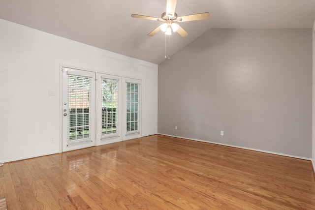 spare room featuring ceiling fan, vaulted ceiling, and light wood-type flooring