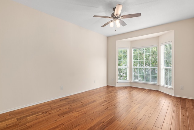 unfurnished room with ceiling fan and light hardwood / wood-style flooring