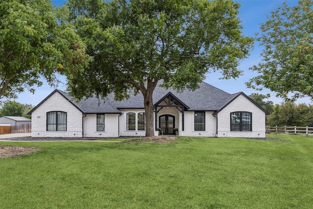 french country inspired facade with a front yard