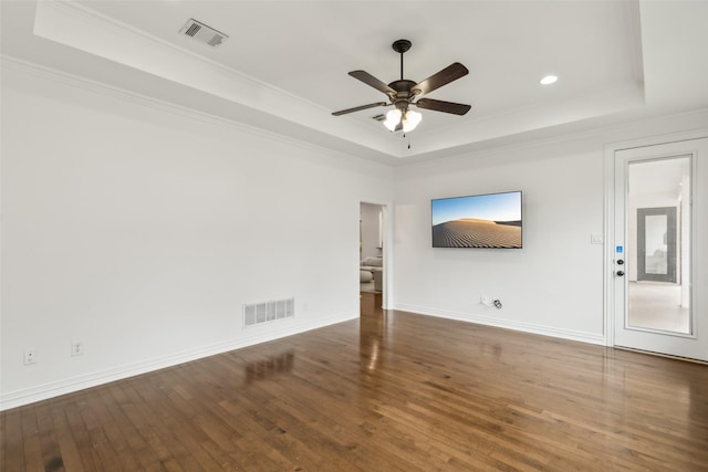 unfurnished living room with a tray ceiling, crown molding, hardwood / wood-style floors, and ceiling fan