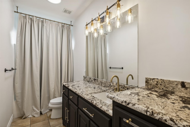 bathroom featuring tile patterned floors, vanity, and toilet