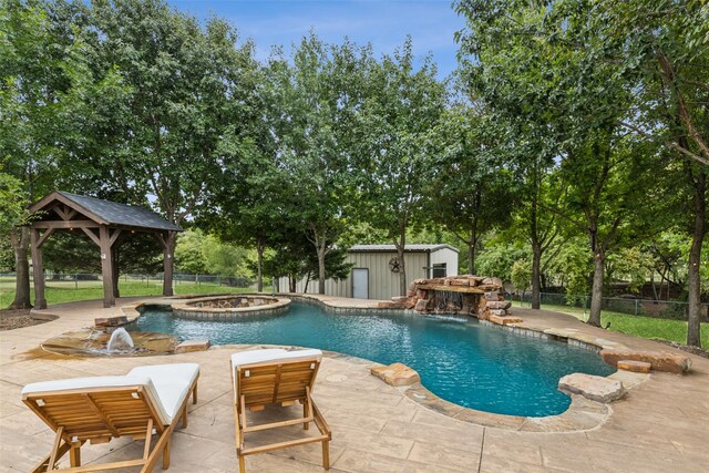 view of pool featuring a gazebo, an outdoor structure, an in ground hot tub, and a patio area