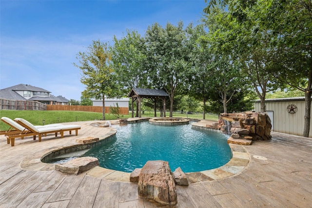 view of pool featuring a lawn, pool water feature, a gazebo, an in ground hot tub, and a patio area