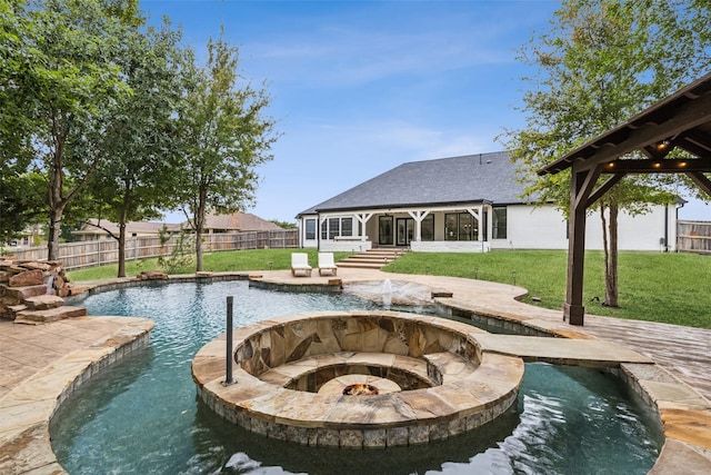 view of pool with a sunroom, an in ground hot tub, and a lawn