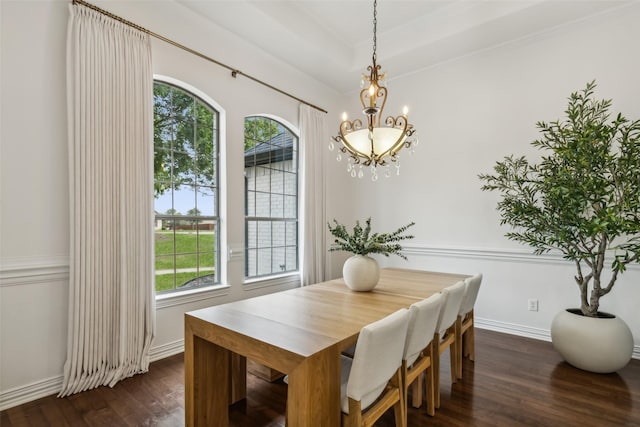 dining room with a notable chandelier, dark hardwood / wood-style flooring, and crown molding