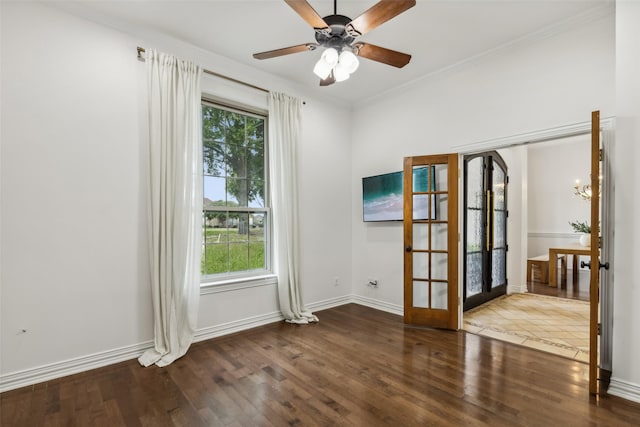 empty room featuring hardwood / wood-style floors, a healthy amount of sunlight, ornamental molding, and french doors