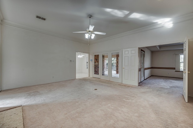 spare room with light carpet, ceiling fan, and crown molding