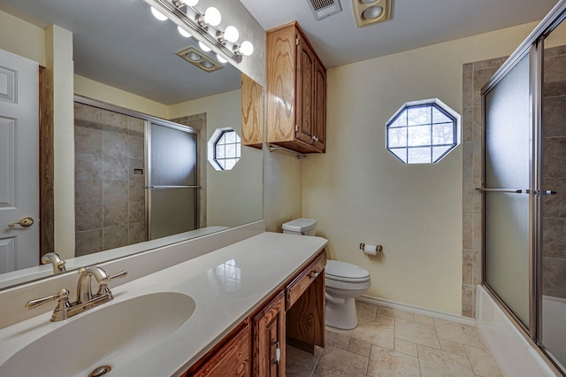 full bathroom featuring vanity, enclosed tub / shower combo, and toilet