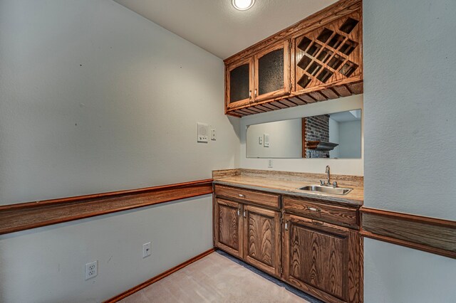 interior space with light colored carpet, sink, and vaulted ceiling