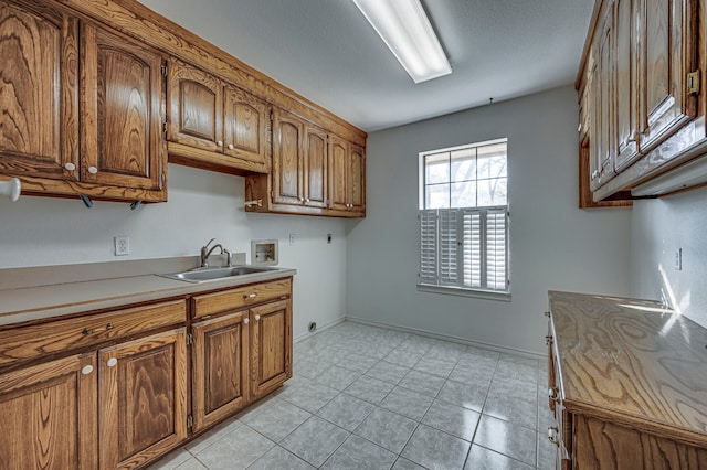 kitchen featuring sink and light tile patterned floors