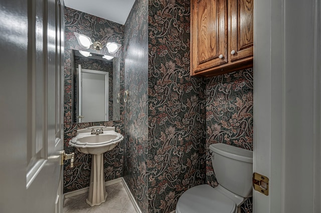 bathroom featuring tile patterned flooring and toilet