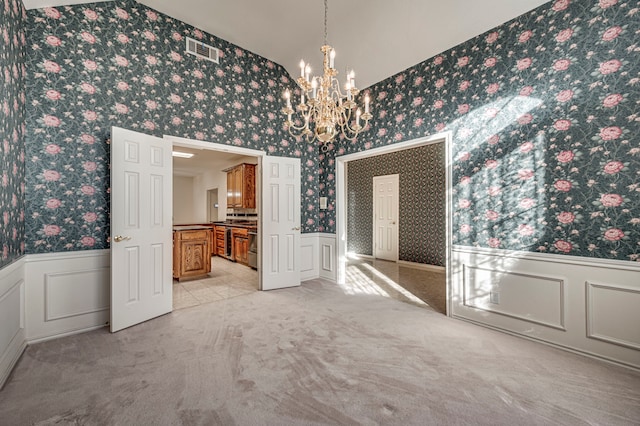 unfurnished dining area with light colored carpet and a chandelier