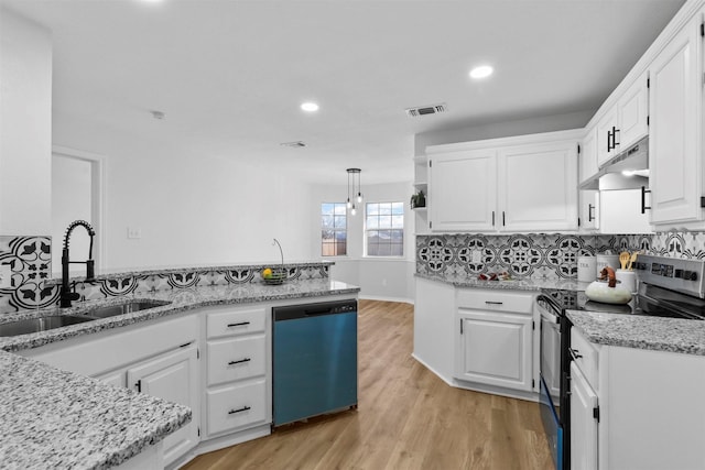 kitchen featuring white cabinets, appliances with stainless steel finishes, decorative light fixtures, and sink