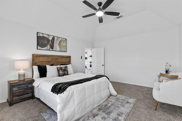 bedroom featuring carpet flooring, vaulted ceiling, a raised ceiling, and ceiling fan