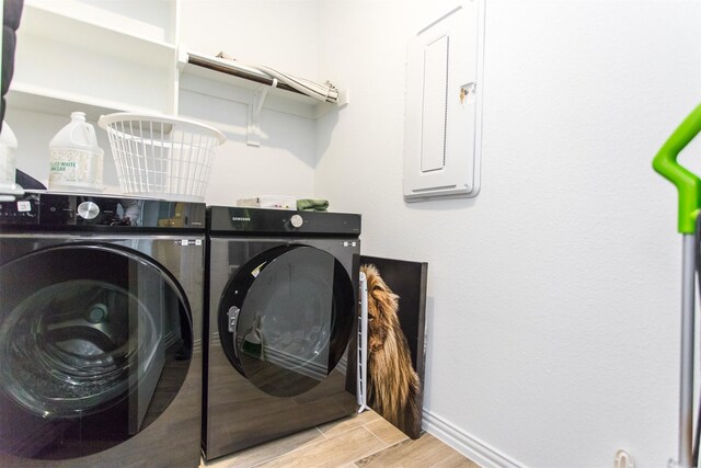 washroom with independent washer and dryer and electric panel