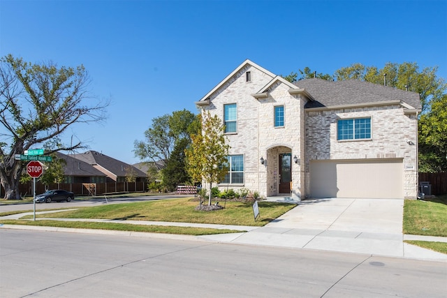 view of front of home featuring a front yard and a garage