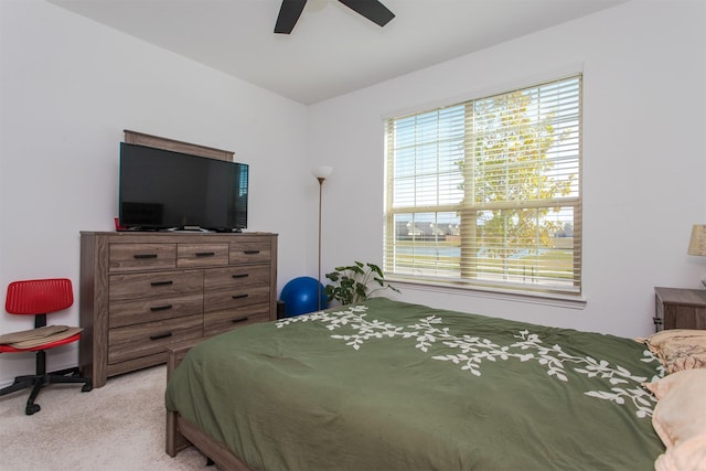 bedroom with ceiling fan and light carpet