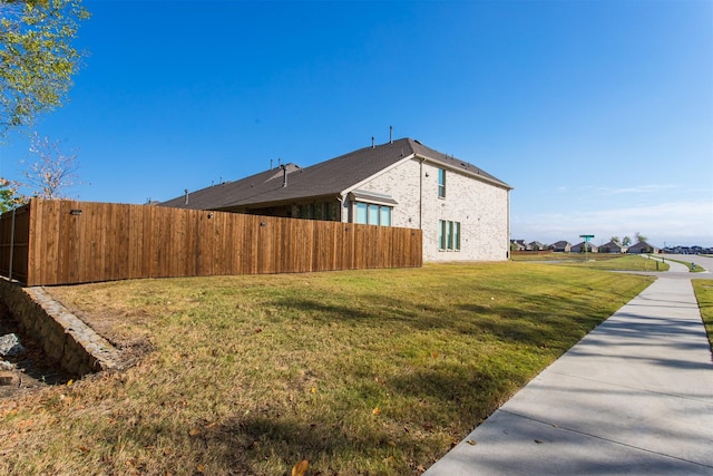 view of property exterior featuring a lawn