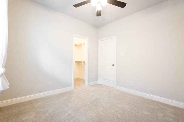 carpeted empty room featuring ceiling fan