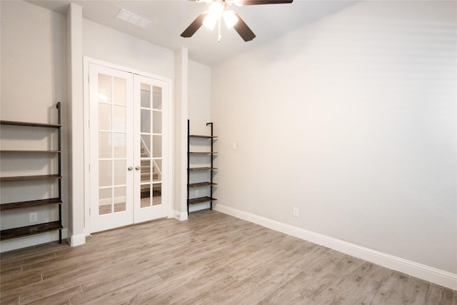 unfurnished room featuring french doors, ceiling fan, and light wood-type flooring