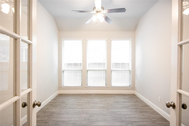 unfurnished sunroom featuring plenty of natural light and ceiling fan