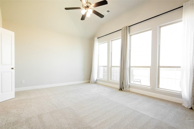 carpeted empty room featuring lofted ceiling and ceiling fan