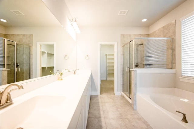 bathroom with tile patterned flooring, vanity, and independent shower and bath