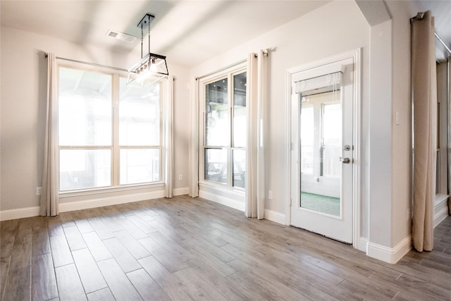 unfurnished dining area with light hardwood / wood-style floors