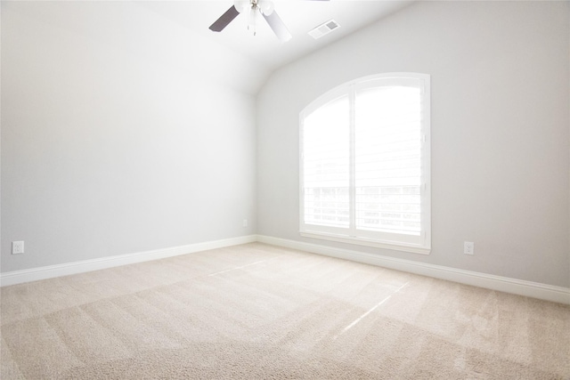 empty room with vaulted ceiling, light carpet, and ceiling fan