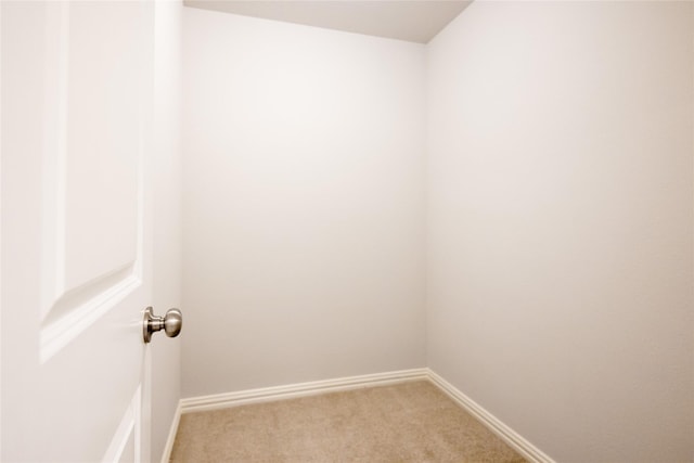 unfurnished room featuring light colored carpet