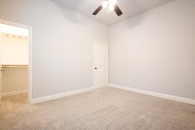 carpeted spare room with ceiling fan