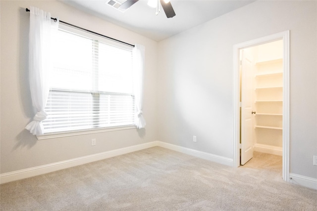 carpeted empty room featuring ceiling fan