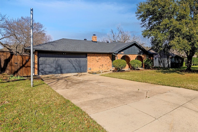 view of front of property with brick siding, concrete driveway, fence, a garage, and a front lawn