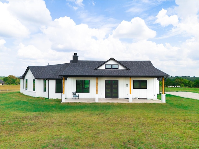 back of house with a patio area, a yard, and french doors