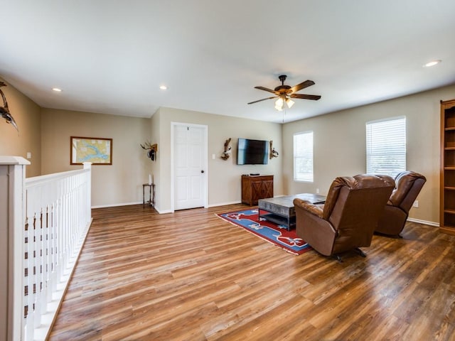 living room featuring ceiling fan and hardwood / wood-style floors