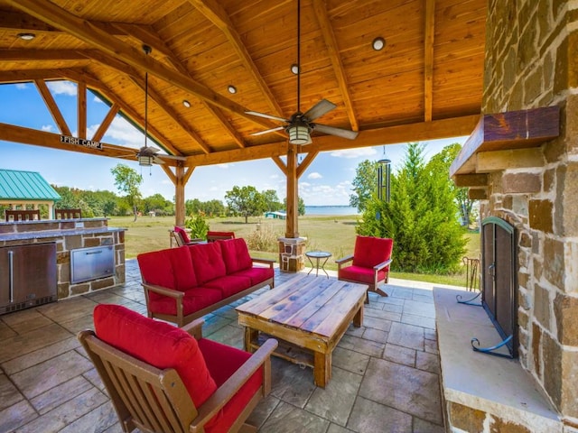 view of patio / terrace with a gazebo, an outdoor living space, ceiling fan, and a water view