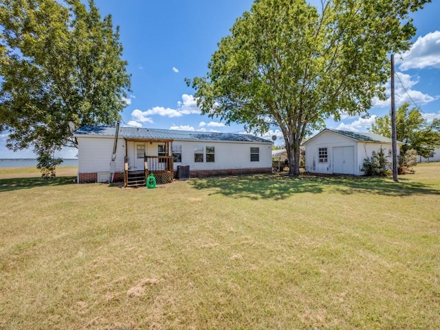 back of property featuring a lawn, a shed, central air condition unit, and a wooden deck