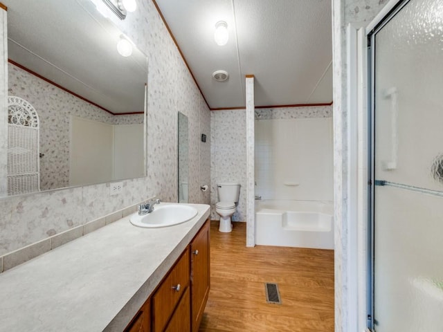 bathroom featuring crown molding, toilet, vanity, and hardwood / wood-style flooring