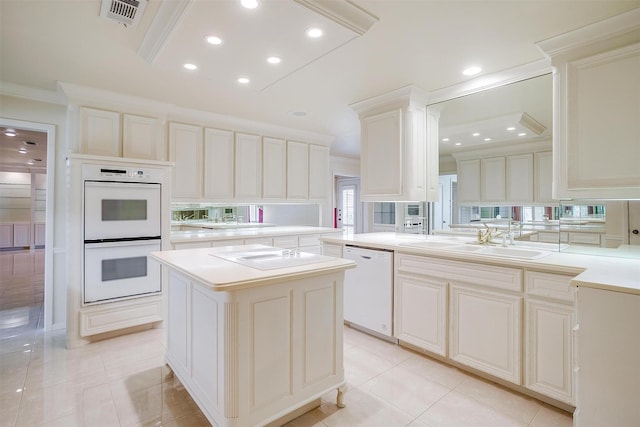 kitchen with sink, crown molding, white appliances, a kitchen island, and kitchen peninsula