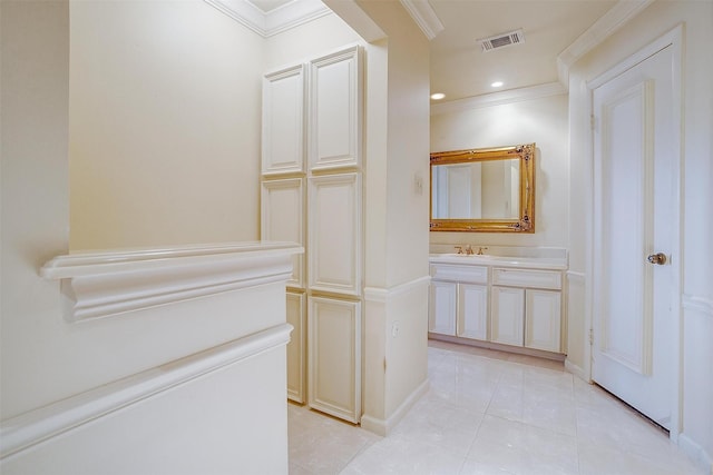 bathroom featuring crown molding, tile patterned floors, and vanity