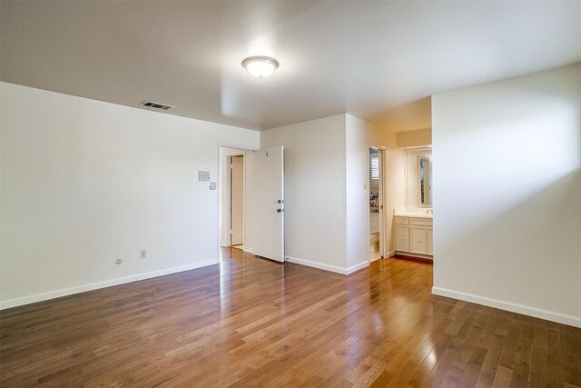 bathroom featuring hardwood / wood-style flooring, vanity, and toilet