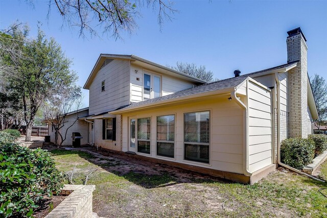 rear view of property with a yard