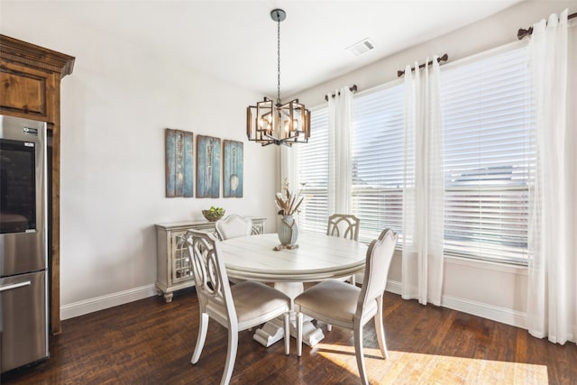 dining room featuring a notable chandelier, dark hardwood / wood-style flooring, and a wealth of natural light