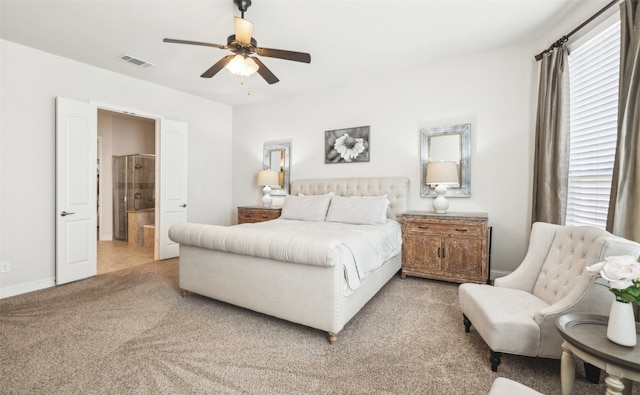 bedroom with multiple windows, carpet, ensuite bathroom, and ceiling fan