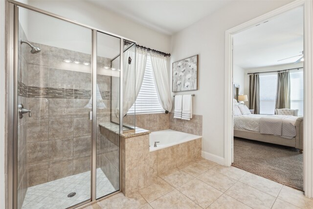 bathroom featuring tile patterned flooring, vanity, and shower with separate bathtub