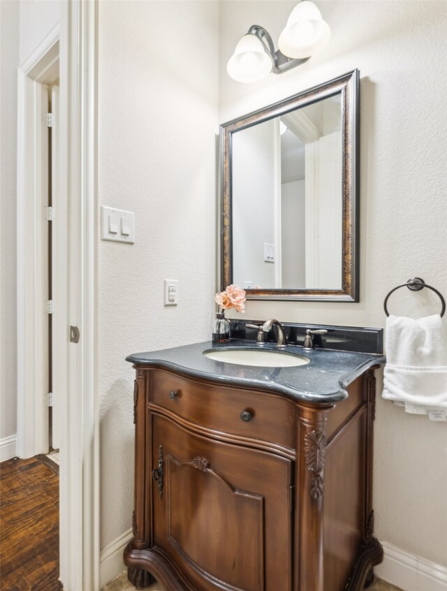 bathroom with hardwood / wood-style floors and vanity