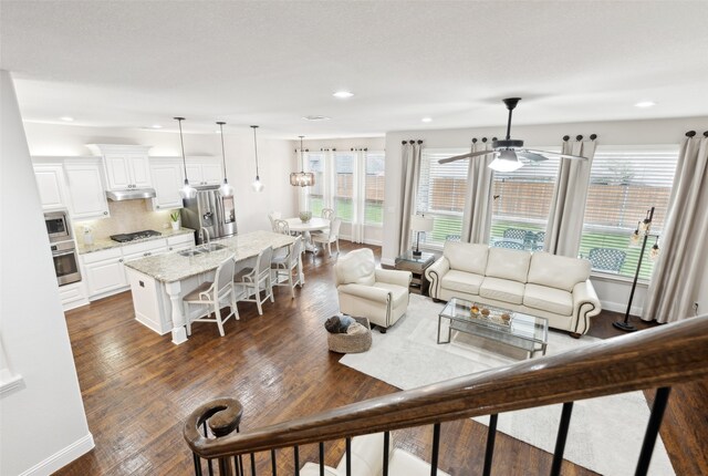 home theater room with ceiling fan, lofted ceiling, and light carpet